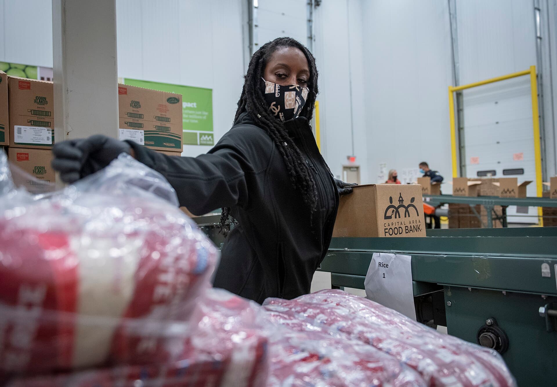 A volunteer bagging produce